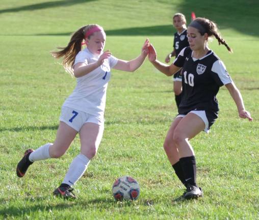 The ball is at the center of attention between Kittatinny's Brooke Bode and Wallkill Valley's Kayla Baker.