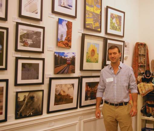 Skylands Gallery show benefits Father John's Animal House James-Jaie Maione, who works with his brother John, to achieve the goals of art gallery, is shown with his photographs.