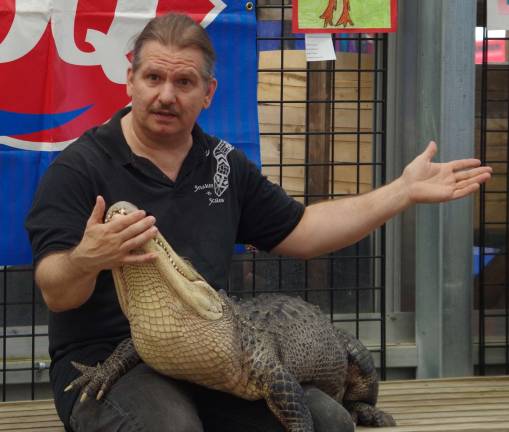 Always a favorite at Vernon&#xfe;&#xc4;&#xf4;s Earthfest, Bill Boesenberg of Snakes-n-Scales is shown with an alligator, one of several reptiles he brought to EarthFest.