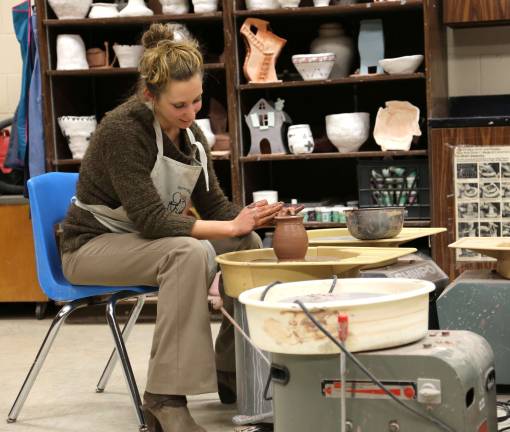 Kelly Kuzicki, one of four fine art teachers at High Point demonstrates the potters wheel at the open house.