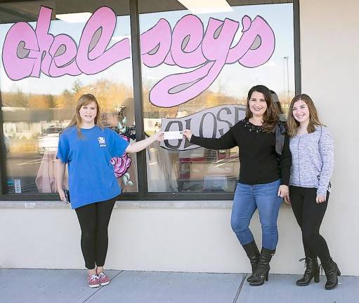 Denise Epright presents the Chelsey’s Closet donation to Rhianna Jameson, communications manager at Father John's Animal House (Photo by Kristy Kryzak at KryzakRed Photography)