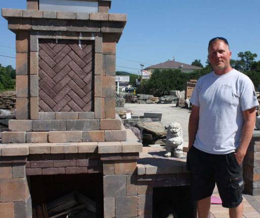 Route 23 Patio &amp; Mason Center manager Sean with an assembled outdoor fireplace kit