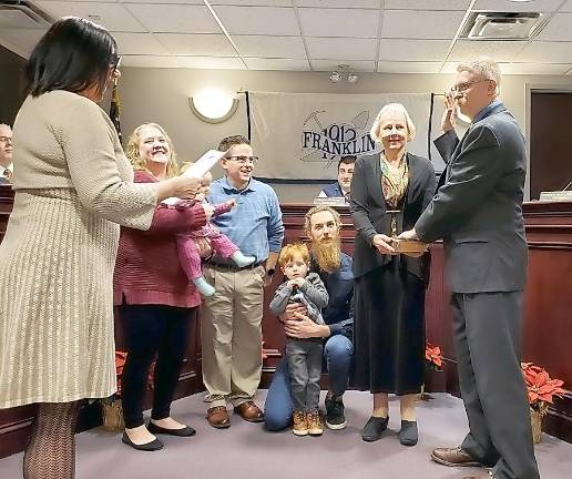 Mayor John M. Sowden IV is joined by his family as he takes the oath of office in Franklin.