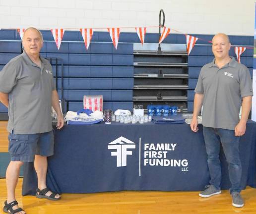 From left, Ken Aulicino and Chad Barris of Family First Funding sponsor the Macaroni Kid Weekend Bag Program Carnival