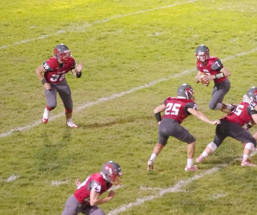 High Point quarterback Alex Buchwald rolls out with the ball as the offensive line holds back the North Warren defense in the first half. Buchwald scored a running touchdown and threw a touchdown pass