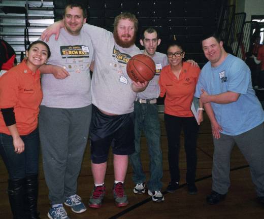 Taking a break between events at the Area 3 Special Olympics Basketball skills meet at the Alfred C. MacKinnon Middle School in Wharton are, from left, Special Olympics volunteer Precsilla Acuria of Hackettstown; Special Olympics athletes Lenny Syfor, Kevin Casey and Scott Dunkerley, all of Hardyston; Special Olympics volunteer Brenadette Acuria of Hackettstown; and Special Olympics athlete Arthur Blanchard of Vernon.