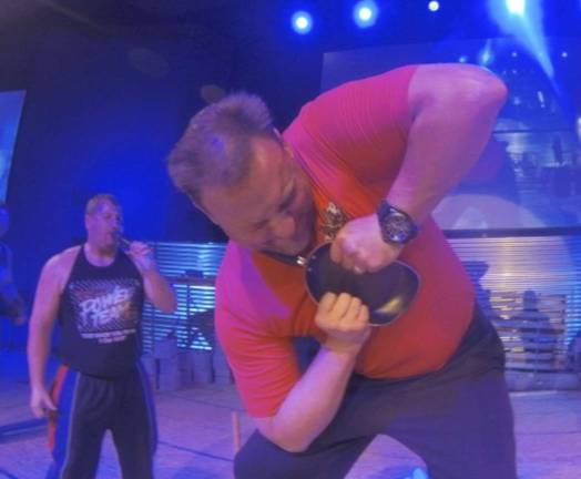 Power team brings inspirational message Bending a steel rod.
