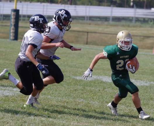 Sussex Tech running back Dylan DeKnight (28) is pursued by Bergen Tech defensive lineman.