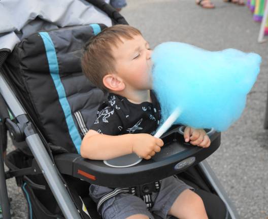 A little boy enjoys his Dairy Swirl cotton candy.