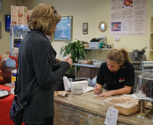 Repeat Customer Adrienne Wieladek, left, orders an Italian Hoagie from Rebecca Shephard.