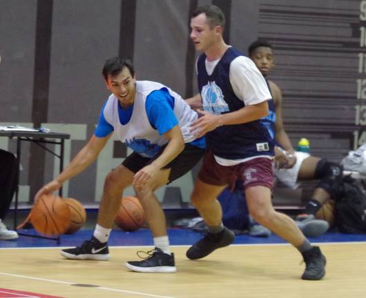 Team Tobin's Zach Frick handles the ball while covered by Team Melvilles Jake Melville in the second half. Frick scored 14 points. Both players are graduates of Sparta High School where they played basketball.