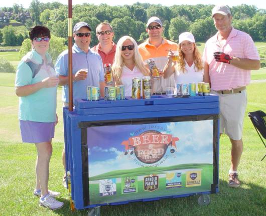 The Wallerius and Whiting Teams enjoy a Brew Station with fellow golfers served by Kohler staffer Kelly