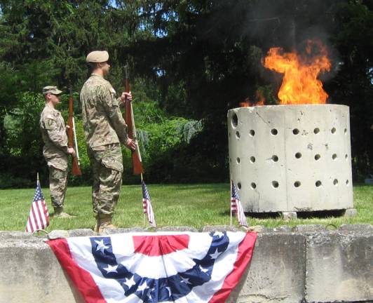 The pit is ignited and the retired flags are honorably disposed of.