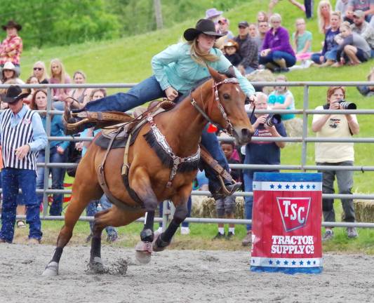 Green Valley Farm hosts rodeo A cowgirl and her horse move fast in the barrel racing event.