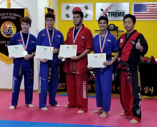 Four black belt students from Master Ken's Xtreme Martial Arts Center recently received the President's Volunteer Service Award. From the picture, left, Nathan Henry, Sergio Quiros, Joseph Pokrywka, Sahas Suri and Master Ken Lee. Visit www.MasterKens.com for more info.