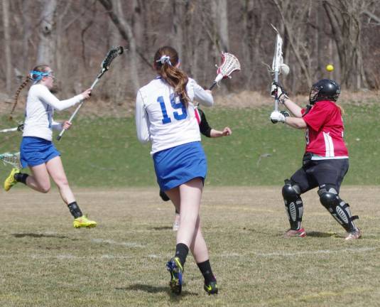 At left Lindsay McKim (yellow Nikes) fires the ball toward the goal post late in the game.