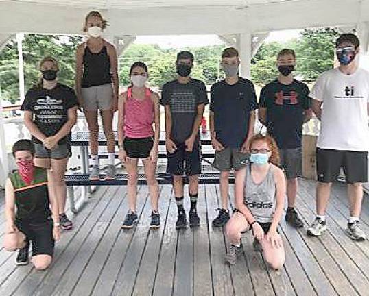 The masked runners: Members of the Kittatinny Regional High School Cross Country Team wear masks while discussing the day's workout. Masks are required at all practices except when teams are socially distancing. (Photo by Laurie Gordon)