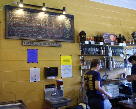 The official pint tally for the fundraiser is shown on the wall behind the bar.