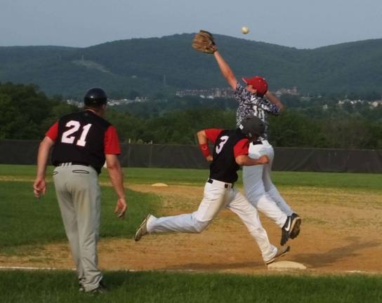 The ball sails over Franklin first baseman Anthony Valilla as Whippanong runner Andrew Paine arrives safe at first base.