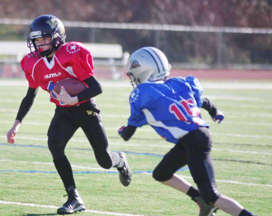 Red All-Stars ball carrier Dyllan Connors on the move in the Super PeeWees game. Connors plays for the West Milford Junior Highlanders.