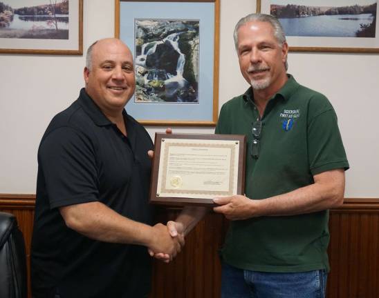 Photos by Vera Olinski Ogdensburg Mayor Steven Ciasullo, left, presents the proclamation declaring May as First Aid month to Ogdensburg First Aid President and Captain Alan Arduini.