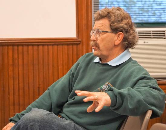 Resident Eric Schmidl discusses tax lien properties and fire equipment with Ogdensburg Council officials.