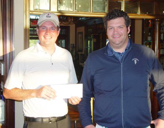 Kevin Teed accepts his closest to the pin prize from James Fox