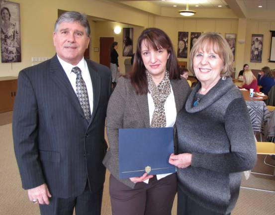 Sussex County Surrogate Gary Chiusano (left) and Special Probate Clerk Laura Camp (right) congratulate Project Self-Sufficiency Higher Opportunities for Women graduate Linda Osmani (center).