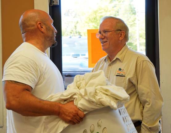 Windy Hills completes upgrades Gary Gardner, on right, greets customer Tony Germano, on left.