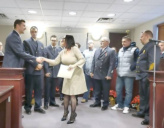 Acting Franklin Borough Clerk Darlene Tremont congratulates the line and administrative Officers of the Franklin Fire Department.