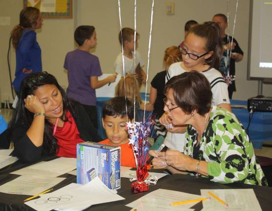 Students participate in an exciting game of Jeopardy.