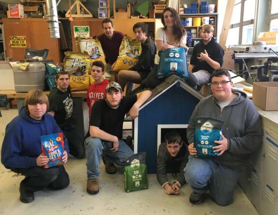 Mr. Wagner and his students display the completed dog house.