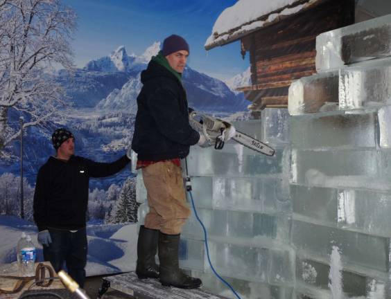 From left, ice sculptors John Morton and Joshua Clemens are shown preparing another frozen wonder.