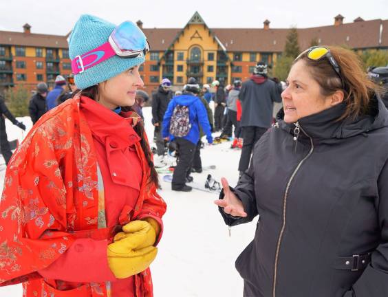 PHOTOS BY VERA OLINSKI Giselle Ioannidis, on right, tells Eva Bonner, on left, how fabulous Chinese New Year is at Mountain Creek.