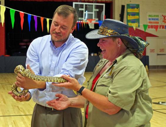 2015: The year in pictures Both Hamburg SchoolþÄôs Chief School Administrator Roger Jinks, Jr. and Vice Principal Mrs. Jacqueline Kartanos got to handle the a nearly six-foot long king snake on May 29 as a reward for a successful project by the students.