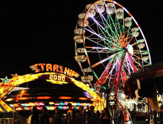 Summertime means County Fair The fairgrounds rides glisten at night. Photo by Nicholas Ortiz