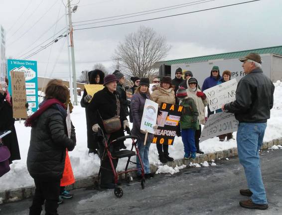 Sparta resident Mike Vrabel, on the right in the green cap, addresses fellow demonstrators in the bitter cold
