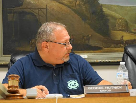 PHOTO BY VERA OLINSKI. Mayor George Hutnick discusses water grant money for Heater's Pond weed control.