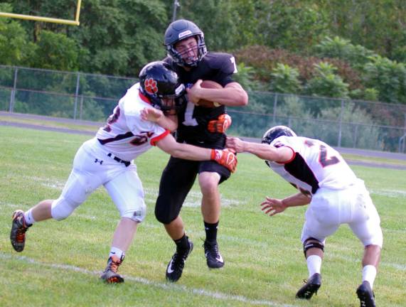 Wallkill Valley quarterback Alex Mastroianni is caught in the open field by Hackettstown linebackers Jared Bernard and Shawn Burke.