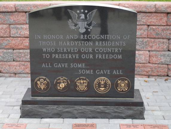 The memorial with the names of veterans inscribed in the bricks surrounding the stone.