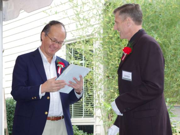 At left, Ambassador Reiichiro Takahashi, the Consul-General of Japan in New York City, is presented with a token of appreciation by Derek Cooke, a co-owner of Abbey Glen Pet Memorial Park.