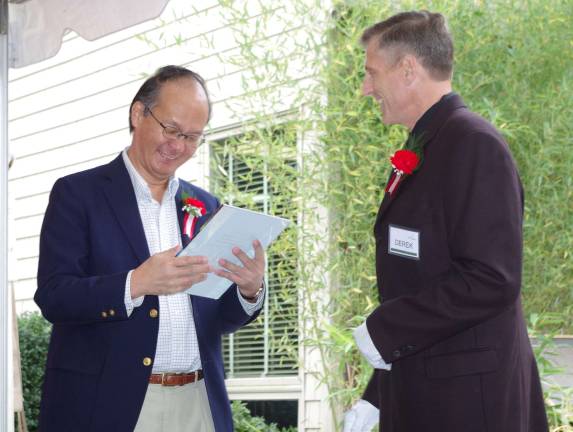 Bond between a man and his dog is a legend At left, Ambassador Reiichiro Takahashi, the Consul-General of Japan in New York City, is presented with a token of appreciation by Derek Cooke, a co-owner of Abbey Glen Pet Memorial Park.