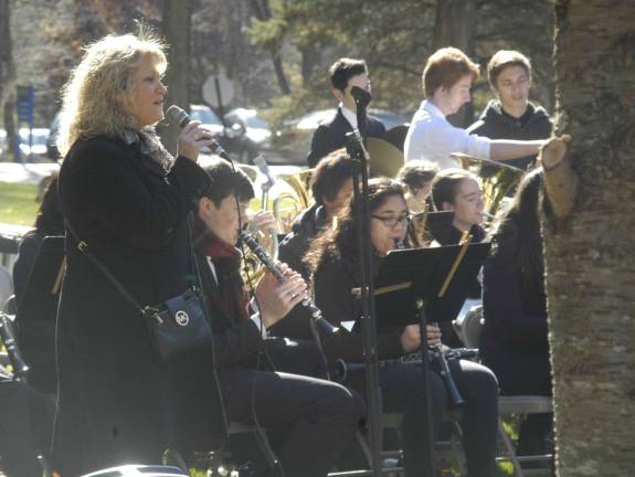 Colleen Van Oudenaren sings the National Anthem accompanied by the Jefferson Township High School Band at the Veterans Day Observance in Jefferson Township.