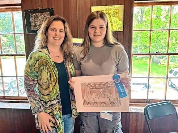 Ogdensburg art students honored Ogdensburg School art teacher Wendy Ransom poses with eighth-grader Cassidy Lairson, who won first place for her artwork, ‘The Cat Supper.’
