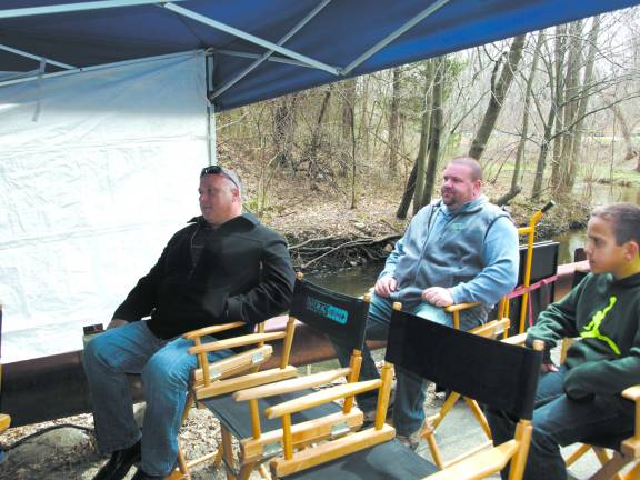 (L to R) Ogdensburg Mayor Steve Ciasullo, his son Antonio Ciasullo, and Ogdensburg council member Robert McGuire watch the filming process on a remote monitor set up just outside of the Cork Hill Road Tunnel.