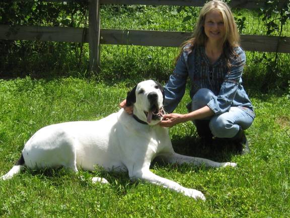 Adult therapy in a farm presence PHOTO BY JANET REDYKE Speech Pathologist Diane Simon poses with farm dog Moe who greets and adores therapy patients. Simon hopes to one day have Moe certified as a therapy dog.