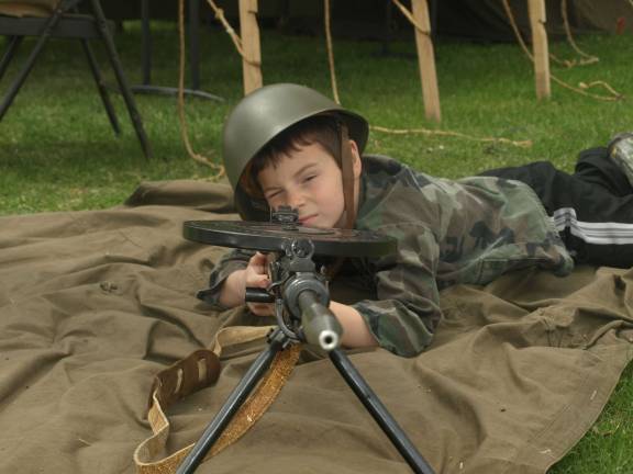 Military vehicles, troops occupy fairgrounds Luke Ceppler , 8, of Stillwater with a Russian GP28 machine gun.