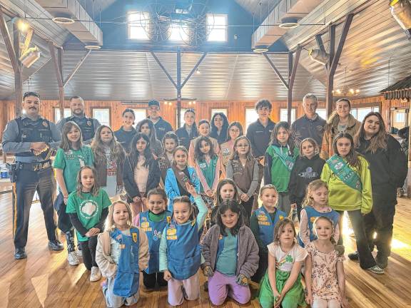 First-responders offer safety tips to Girl Scouts First-responders pose with Girl Scouts from Andover, Green Township and Newton.