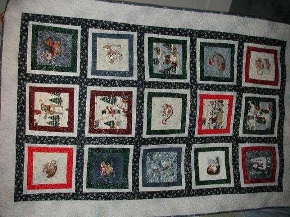 Area sewing clubs needle away An embroidered blanket.