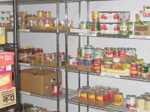 Shelves at Harvest House half-filled with ingredients for hot daily meals. (Photo by Janet Redyke)